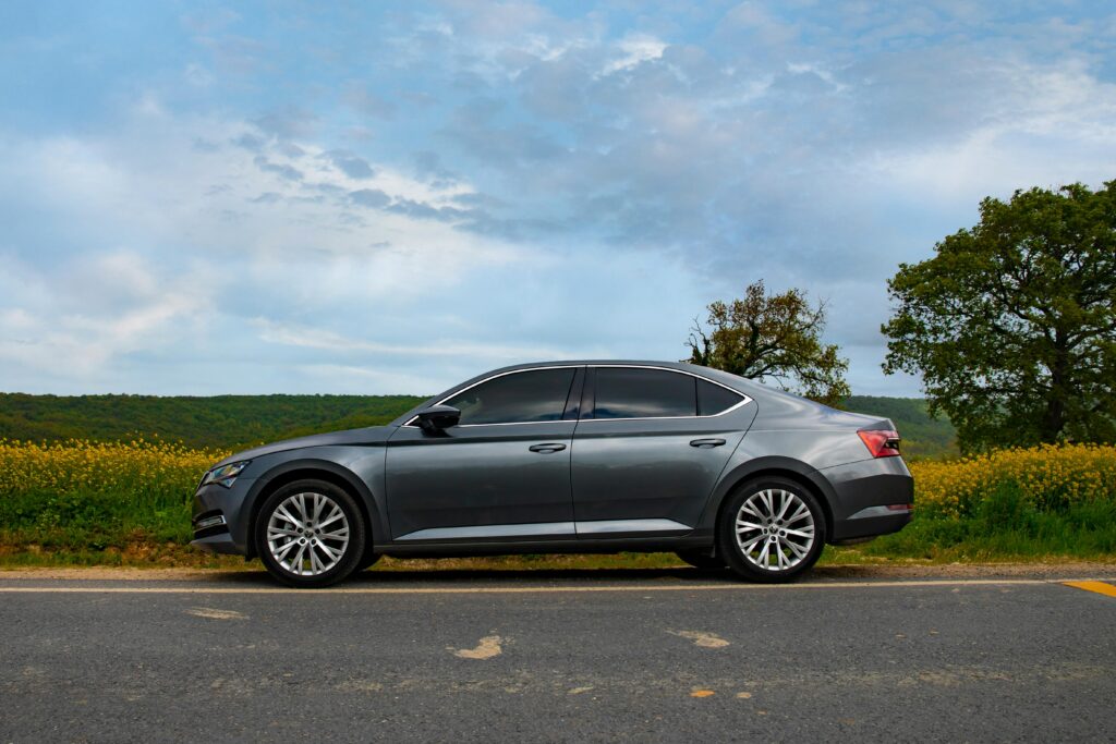 Skoda Superb on the Road with a Countryside Landscape in the Background